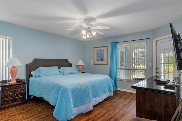 bedroom featuring access to outside, dark wood-style floors, ceiling fan, and baseboards