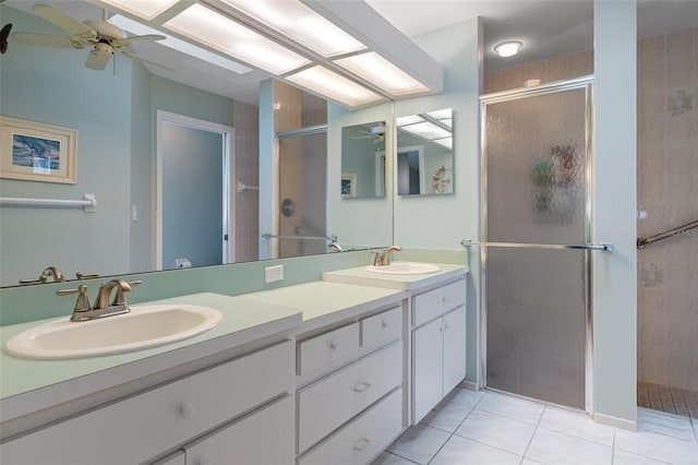 bathroom with a ceiling fan, a shower stall, and tile patterned floors