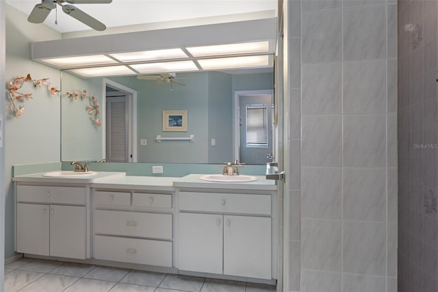 full bath with ceiling fan, double vanity, and tile patterned flooring