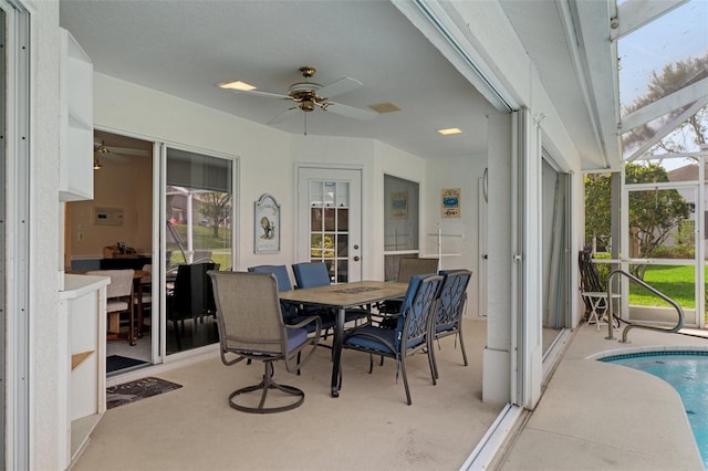 sunroom with ceiling fan, healthy amount of natural light, and french doors