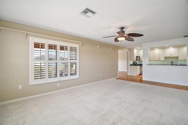 7355 SE 106th Pl, Belleview, FL 34420 - unfurnished living room with carpet, a ceiling fan, and baseboards