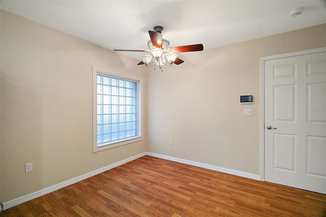 7355 SE 106th Pl, Belleview, FL 34420 - empty room with a smoke detector, ceiling fan, baseboards, and wood finished floors