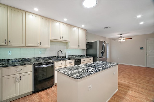 7355 SE 106th Pl, Belleview, FL 34420 - kitchen with black dishwasher, a sink, stainless steel fridge, ceiling fan, and light wood finished floors