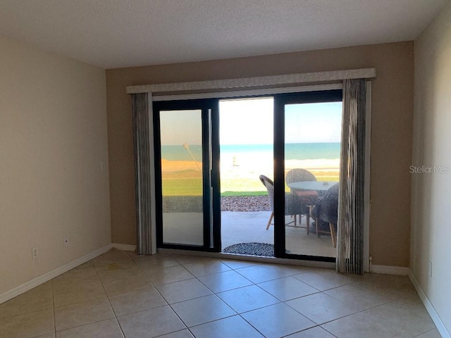 2600 Ocean Shore Blvd Unit 111, Ormond Beach, FL 32176 - unfurnished room with baseboards and light tile patterned floors