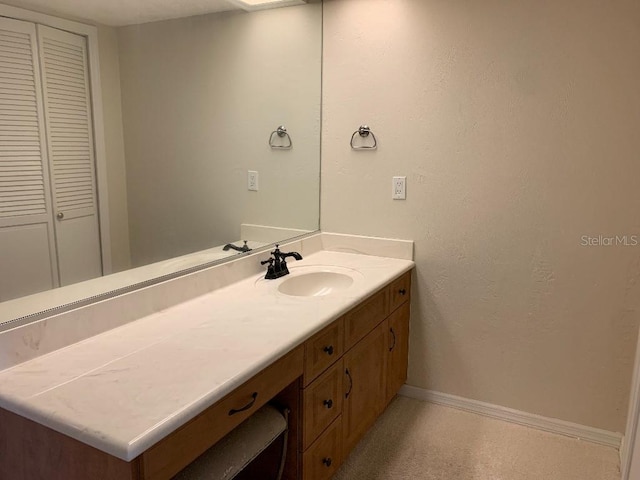 2600 Ocean Shore Blvd Unit 111, Ormond Beach, FL 32176 - bathroom featuring baseboards and vanity
