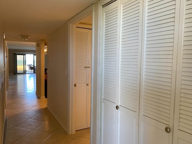 2600 Ocean Shore Blvd Unit 111, Ormond Beach, FL 32176 - hall featuring light tile patterned flooring and baseboards