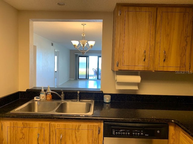 2600 Ocean Shore Blvd Unit 111, Ormond Beach, FL 32176 - kitchen featuring dishwasher, a sink, brown cabinetry, a chandelier, and decorative light fixtures