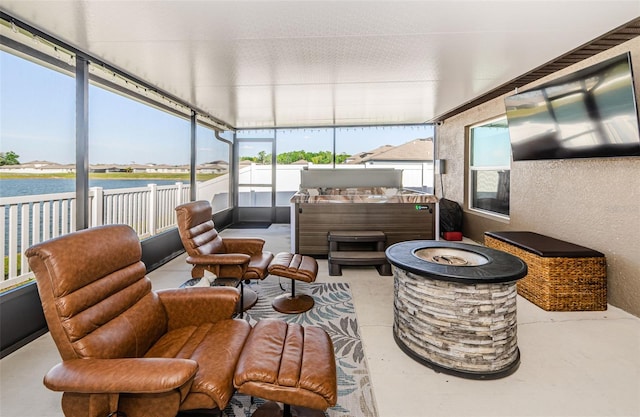 36419 Flats St, Zephyrhills, FL 33541 - sunroom / solarium with a hot tub, a water view, an outdoor fire pit, and concrete flooring
