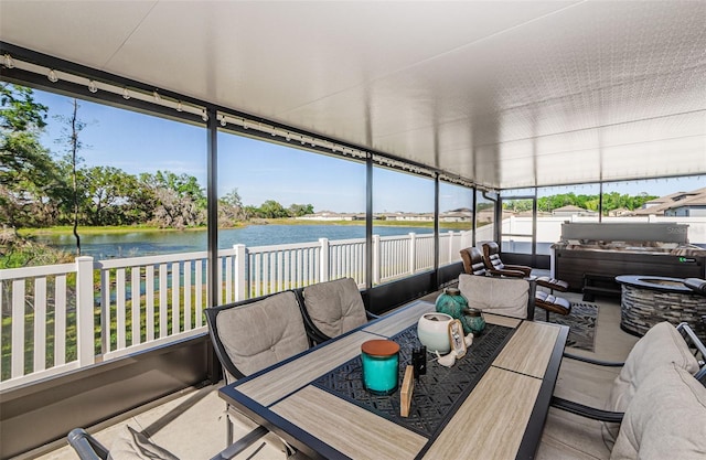 36419 Flats St, Zephyrhills, FL 33541 - sunroom / solarium featuring a jacuzzi, outdoor lounge area, a water view, and outdoor dining space