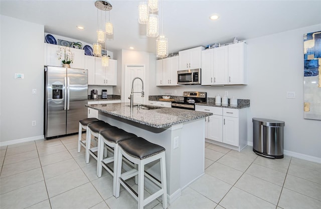 36419 Flats St, Zephyrhills, FL 33541 - kitchen with appliances with stainless steel finishes, a sink, light stone countertops, light tile patterned flooring, and recessed lighting