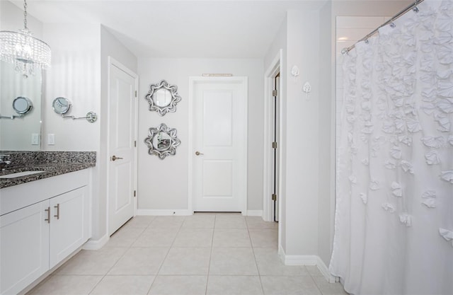 36419 Flats St, Zephyrhills, FL 33541 - bathroom featuring tile patterned flooring, baseboards, a chandelier, vanity, and curtained shower