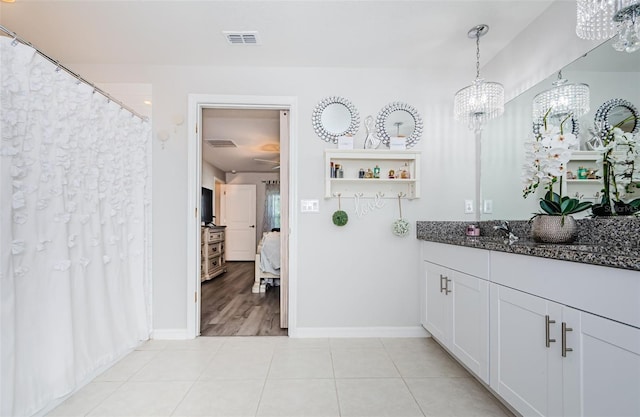 36419 Flats St, Zephyrhills, FL 33541 - ensuite bathroom with a chandelier, baseboards, tile patterned flooring, and vanity