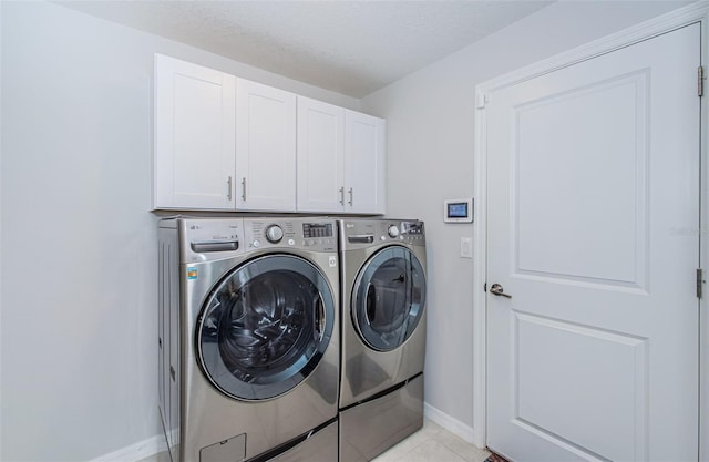 36419 Flats St, Zephyrhills, FL 33541 - washroom with washing machine and dryer, cabinet space, baseboards, and light tile patterned flooring