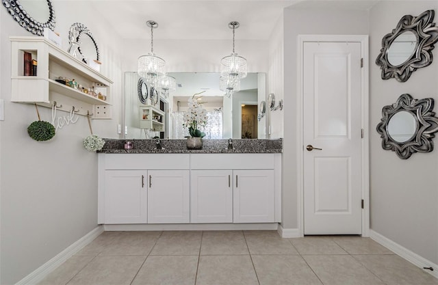 36419 Flats St, Zephyrhills, FL 33541 - bathroom with a chandelier, tile patterned floors, baseboards, and double vanity