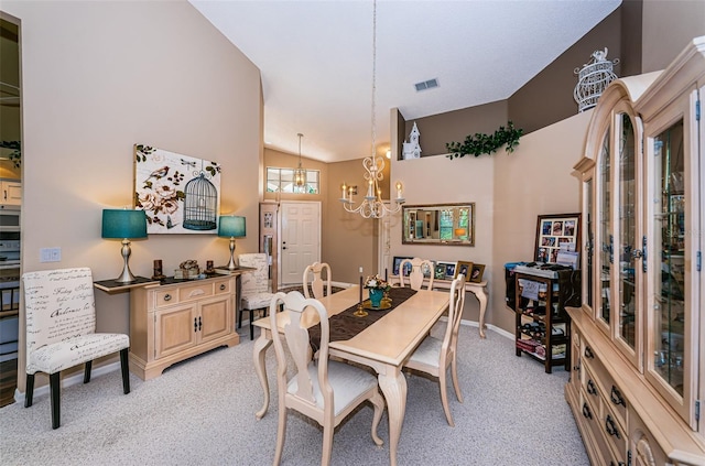 9636 Brookdale Dr, New Port Richey, FL 34655 - dining area featuring light colored carpet, vaulted ceiling, baseboards, a chandelier, and visible vents
