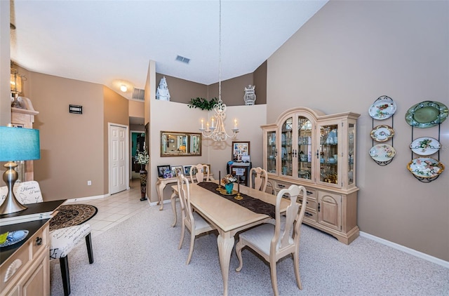 9636 Brookdale Dr, New Port Richey, FL 34655 - dining area with a notable chandelier, high vaulted ceiling, light tile patterned floors, baseboards, and visible vents