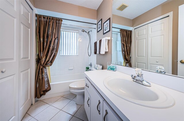 9636 Brookdale Dr, New Port Richey, FL 34655 - full bathroom featuring a textured ceiling, visible vents, toilet, vanity, and tile patterned flooring