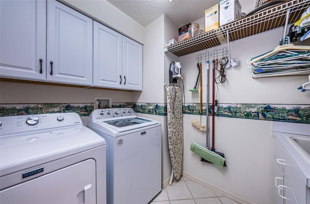 9636 Brookdale Dr, New Port Richey, FL 34655 - washroom with light tile patterned flooring, cabinet space, a textured ceiling, and washer and dryer