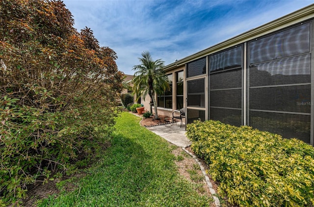 9636 Brookdale Dr, New Port Richey, FL 34655 - view of yard with a sunroom and a patio area