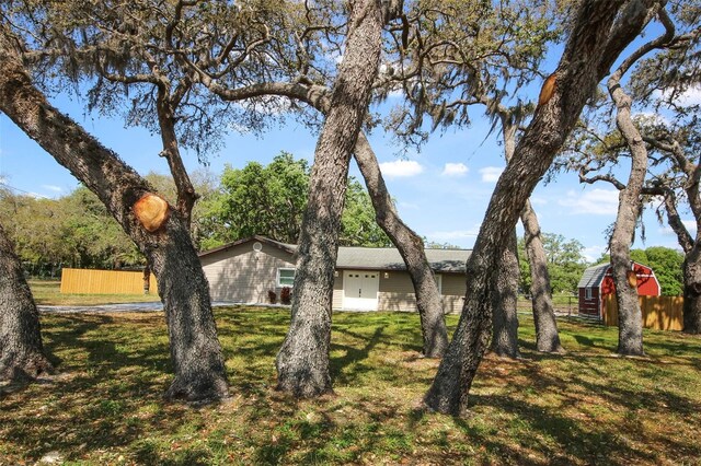 view of property exterior featuring fence and a yard