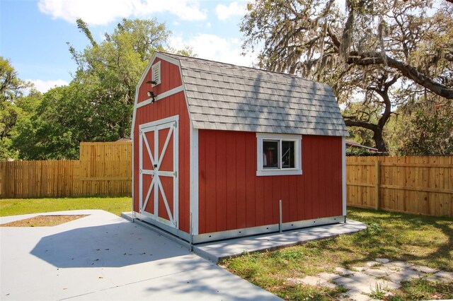 view of shed with a fenced backyard