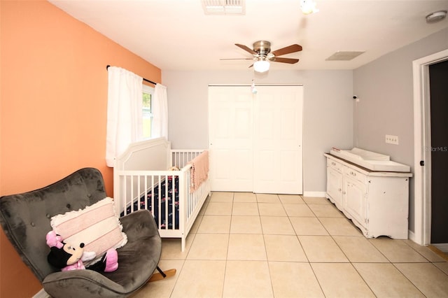 bedroom featuring a ceiling fan, light tile patterned floors, a closet, and visible vents