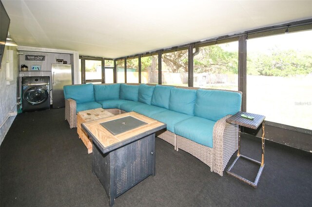 sunroom / solarium with an outdoor hangout area and washer / clothes dryer