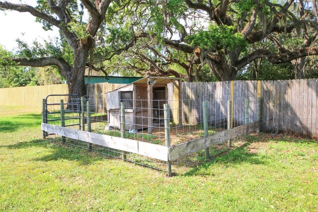 view of yard with an outdoor structure and a fenced backyard