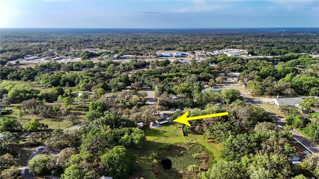 birds eye view of property with a forest view