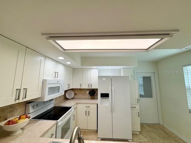 kitchen with white cabinets, white appliances, light countertops, recessed lighting, and tasteful backsplash