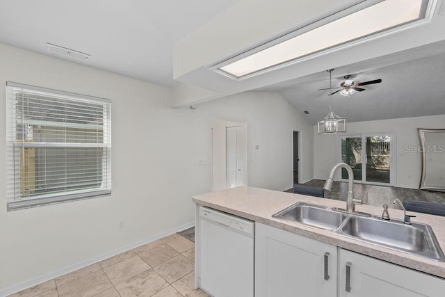 kitchen with visible vents, white cabinetry, a sink, dishwasher, and vaulted ceiling