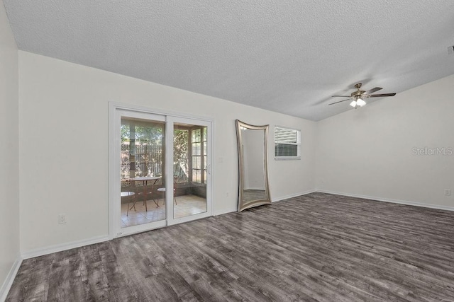 empty room with baseboards, ceiling fan, a textured ceiling, and dark wood-type flooring