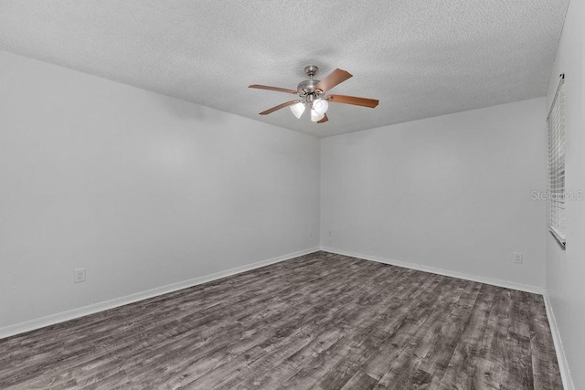 unfurnished room with a ceiling fan, a textured ceiling, dark wood finished floors, and baseboards
