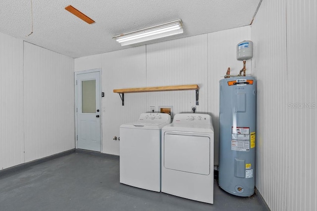 clothes washing area featuring separate washer and dryer, laundry area, a textured ceiling, and electric water heater
