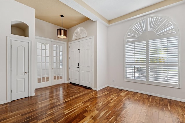 entryway with french doors, baseboards, and wood finished floors