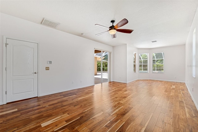 spare room with visible vents, a ceiling fan, light wood-style floors, and baseboards