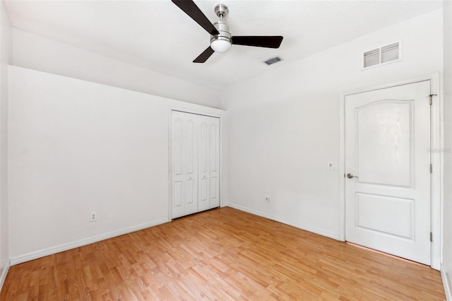 unfurnished bedroom featuring baseboards, light wood-type flooring, and visible vents