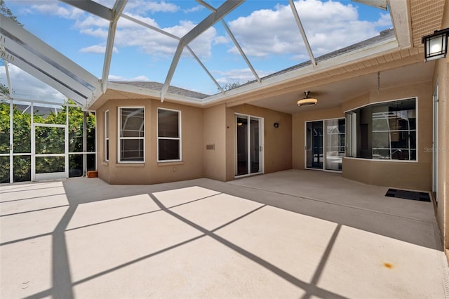 rear view of house featuring a patio, a lanai, and stucco siding