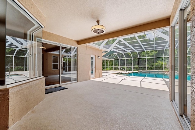 outdoor pool featuring glass enclosure and a patio area