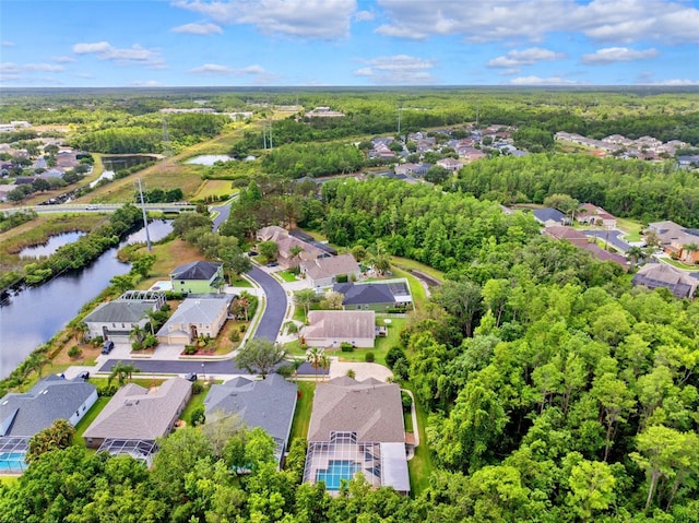 drone / aerial view with a water view and a residential view