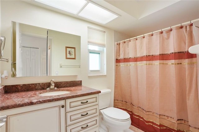 bathroom with a shower with shower curtain, toilet, and vanity
