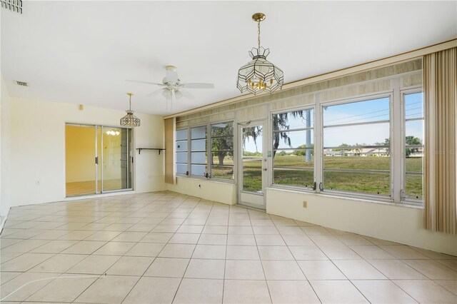 empty room with light tile patterned floors, ceiling fan, and visible vents