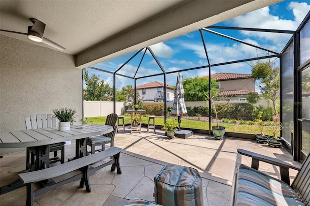 view of patio / terrace with fence, glass enclosure, and outdoor dining space