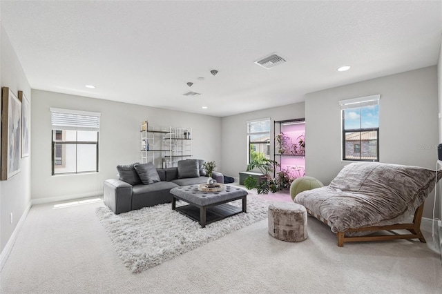 living area with baseboards, visible vents, carpet, and recessed lighting