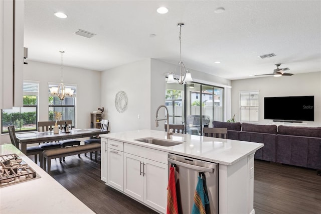 kitchen featuring stainless steel appliances, a sink, dark wood-type flooring, and a wealth of natural light