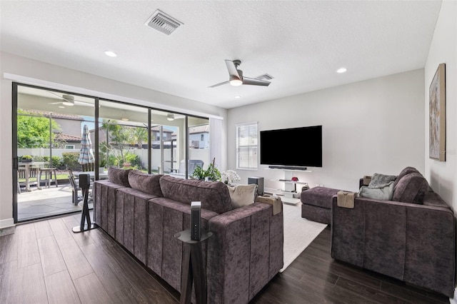 living room with visible vents, recessed lighting, dark wood-type flooring, and ceiling fan
