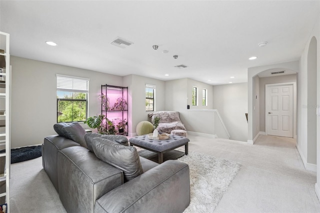living room featuring baseboards, light carpet, visible vents, and recessed lighting