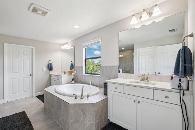 full bath with a bath, visible vents, a sink, and a shower stall
