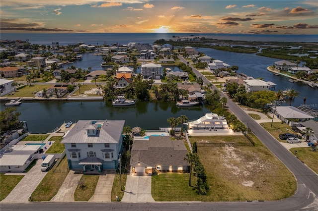 aerial view of residential area featuring a nearby body of water
