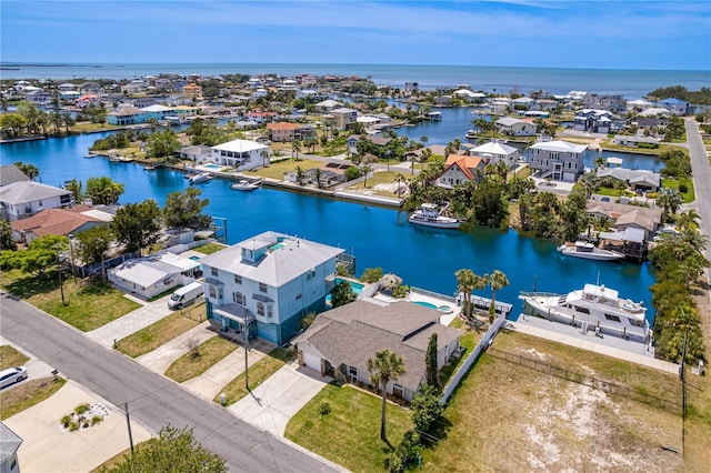 aerial view of residential area featuring a large body of water